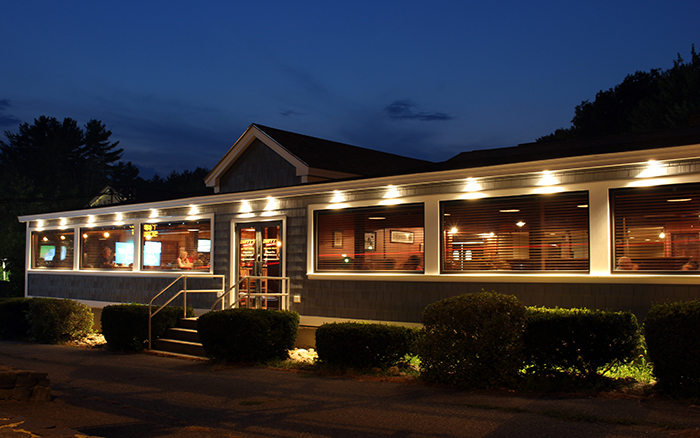 Outside of Birdies restaurant at night with the exterior lights on